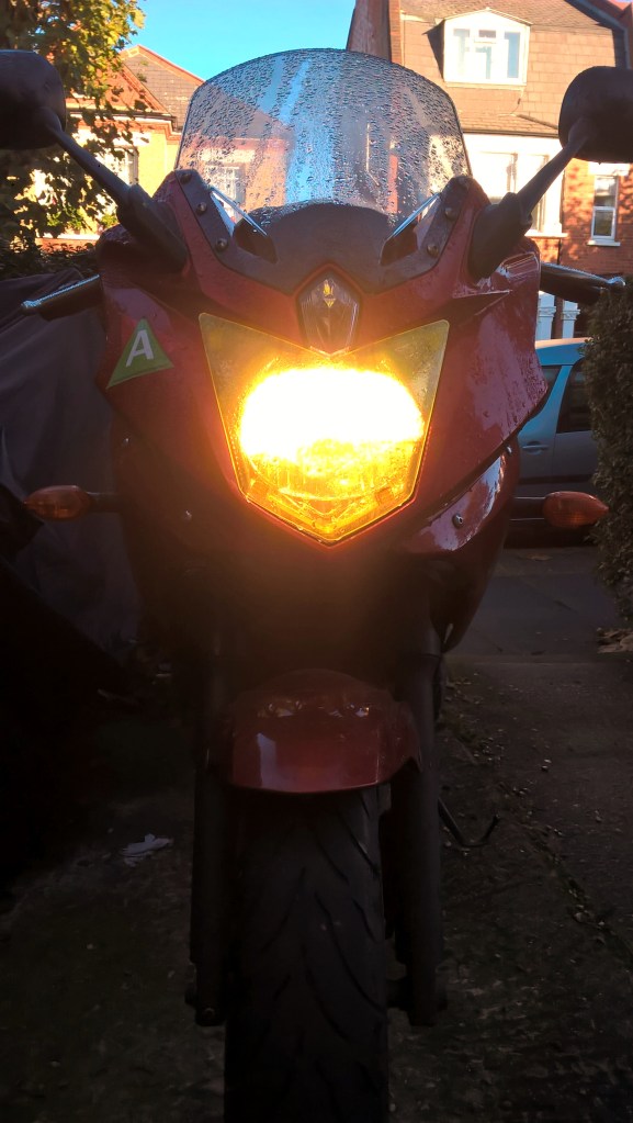 Yellow headlight illuminated on motorcycle